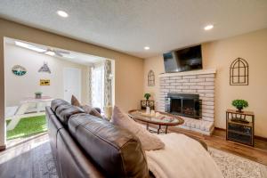 a living room with a couch and a fireplace at Sparks Retreat with Private Hot Tub and Cozy Fireplace in Sparks