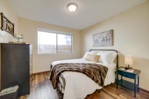 a bedroom with a bed and a window at Sparks Retreat with Private Hot Tub and Cozy Fireplace in Sparks