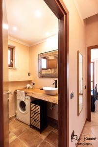 a bathroom with a sink and a washing machine at Terrazza Sulla Luna in Casciana Terme