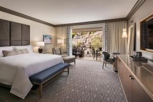 a bedroom with a bed and a living room at The Phoenician, a Luxury Collection Resort, Scottsdale in Scottsdale