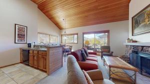 a living room with a couch and a fireplace at Villas at Snowmass Club in Snowmass Village