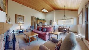 a living room with a couch and a table at Villas at Snowmass Club in Snowmass Village