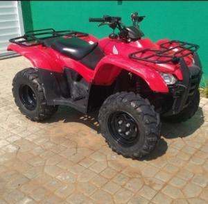 a red four wheeler parked in front of a building at Maravilha em Tibau do Sul in Tibau do Sul