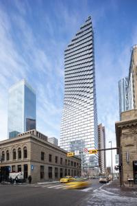 a tall building in a city with a street at Award-Winning One-Bedroom Suite at Telus Sky in Calgary