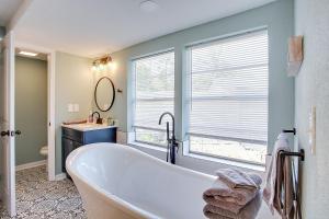 a bathroom with a bath tub and a sink at Modern Retreat Lake House @Lake Talquin in Tallahassee