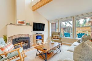 a living room with a fireplace and a tv at Beautiful Seattle Home with Patio about 9 Mi to Downtown in Seattle