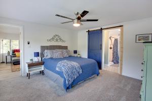 a bedroom with a blue bed and a ceiling fan at Modern Retreat Lake House @Lake Talquin in Tallahassee