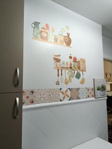 a shelf with a bunch of magnets on a wall at VuT Plaza de la Catedral in Burgos