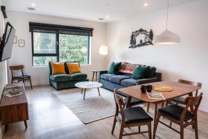 a living room with a couch and a table at Wildflower Retreat by Revelstoke Vacations in Revelstoke