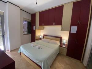 a bedroom with a bed with two towels on it at Home Sweet Home - Guest House in Tirana