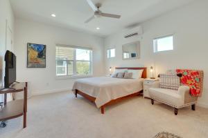 a bedroom with a bed and a chair and a television at San Antonio Oasis Near Riverwalk and Alamo Park! in San Antonio