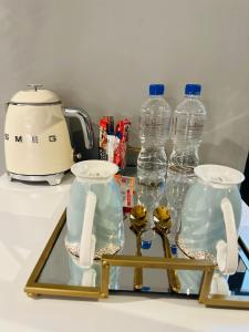 a glass table with two bottles of water on it at Signature Boutique Guesthouse in Maun