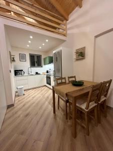 a kitchen and dining room with a wooden table and chairs at Lemon House in Nafplio