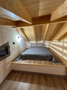 a bed in a loft bedded room with a tv at Lemon House in Nafplio