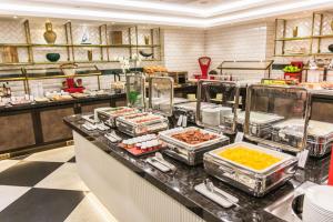 a buffet line in a restaurant with food at Hilton Budapest in Budapest