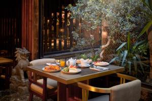 a table with plates of food on top of it at Avani Avenida Liberdade Lisbon Hotel in Lisbon