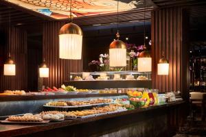 a buffet line with many different types of food at Avani Avenida Liberdade Lisbon Hotel in Lisbon