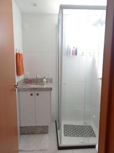 a shower with a glass door in a bathroom at Resort Apto Frente Mar in Barra Velha