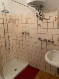 a bathroom with a shower and a sink at Appartamento a Bagolino (BS) in Bagolino