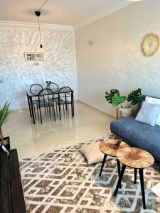 un soggiorno con divano blu e tavolo di Beautiful apartment-High speed WIFI-iPTV-Netflix a El Jadida