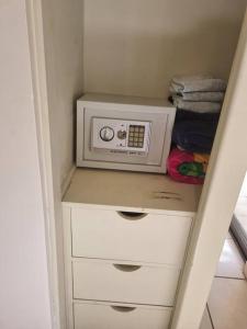 a microwave sitting on a shelf in a closet at Beautiful beach front entire condo in Coco