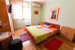 a small bedroom with a bed and a window at Apartment&Rooms "Globus" Mostar in Mostar