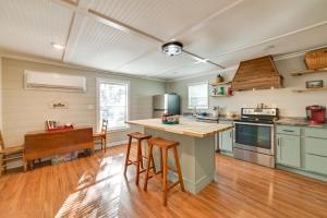 a kitchen with green cabinets and a wooden floor at Pet-Friendly Springville Cabin Near Kentucky Lake! in Durham Subdivision