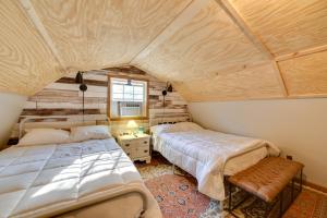 a bedroom with two beds and a window at Pet-Friendly Springville Cabin Near Kentucky Lake! in Durham Subdivision