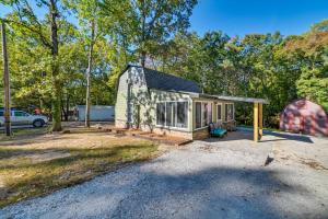 a tiny house in a parking lot with a tent at Pet-Friendly Springville Cabin Near Kentucky Lake! in Durham Subdivision
