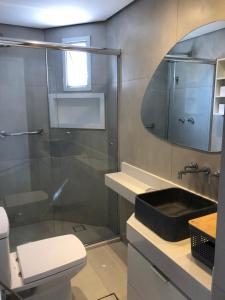 a bathroom with a shower and a toilet and a sink at Royal Ibirapuera Park in São Paulo