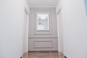 a hallway with a door and a window at Brand new apartment close to Valletta in Tal-Pietà