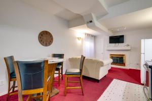 a living room with a table and chairs and a couch at Convenient Denver Apartment about 10 Mi to Downtown! in Aurora