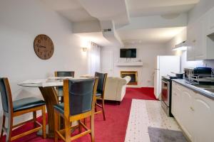 a kitchen and dining room with a table and chairs at Convenient Denver Apartment about 10 Mi to Downtown! in Aurora