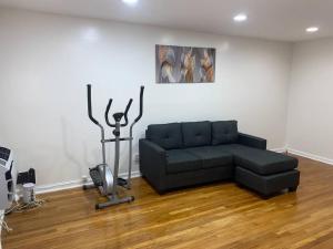 a black couch sitting in a living room at Cozy 2-bedrooms bungalow in Canarsie Brooklyn in Brooklyn