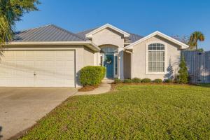 a house with a driveway and a garage at Family-Friendly PCB Vacation Rental, Walk to Beach in Panama City Beach