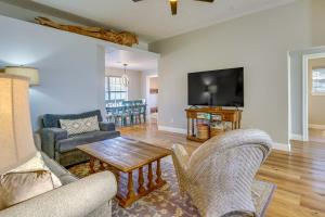 a living room with two chairs and a tv at Family-Friendly PCB Vacation Rental, Walk to Beach in Panama City Beach