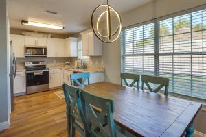 a kitchen with a wooden dining table and chairs at Family-Friendly PCB Vacation Rental, Walk to Beach in Panama City Beach