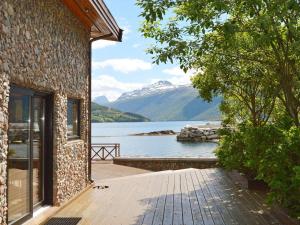 a house with a view of a lake and mountains at 10 person holiday home in EIDSVÅG-By Traum in Rød