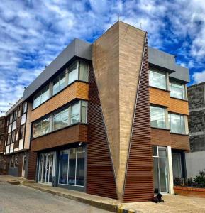 a large building with a wooden facade on a street at Hotel Santa Elena Norte in Tunja