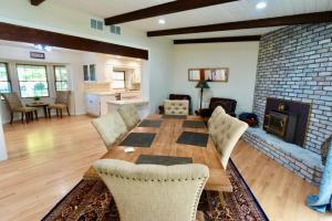 a living room with a wooden table and a fireplace at Modern Charm Meets Cozy Elegance in Fowler
