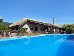 a large swimming pool in front of a house at Six-Bedroom Holiday home in Eidsvåg in Eidsvåg