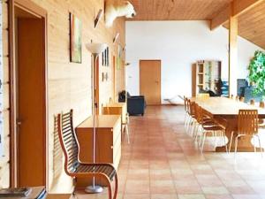 a room with a table and chairs and a dining room at Six-Bedroom Holiday home in Eidsvåg in Eidsvåg