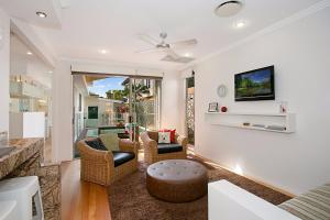 a living room with a couch and a table at Tobys Beach House in Gold Coast