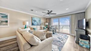 a living room with a couch and a tv at Crystal Dunes 405 - 3 BR Beach Front in Destin