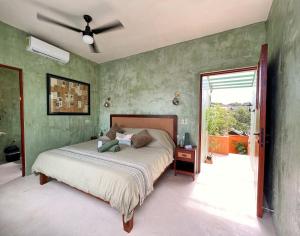 a bedroom with a bed and a ceiling fan at Kuka y Letras in Mérida