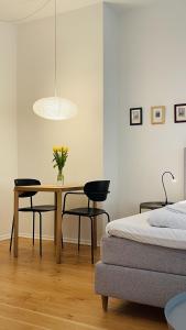 a bedroom with a table and two chairs and a bed at ApartmentInCopenhagen Apartment 1539 in Copenhagen