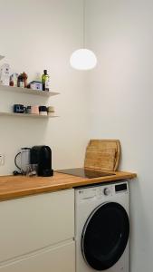 a kitchen with a washing machine under a counter at ApartmentInCopenhagen Apartment 1539 in Copenhagen