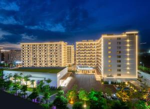 vista su un grande edificio di notte di Rezen Select Hotel guagnzhou Baiyun International Airport T2 Canton Fair Certificate Application & Free Shuttle a Huadu