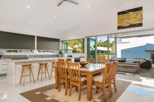 a kitchen and dining room with a table and chairs at A Perfect Stay - Aditi in Byron Bay