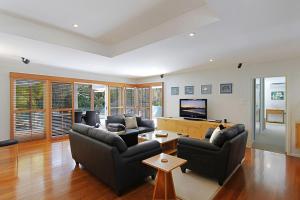 a living room with couches and a flat screen tv at A Perfect Stay - Abode at Byron in Ewingsdale